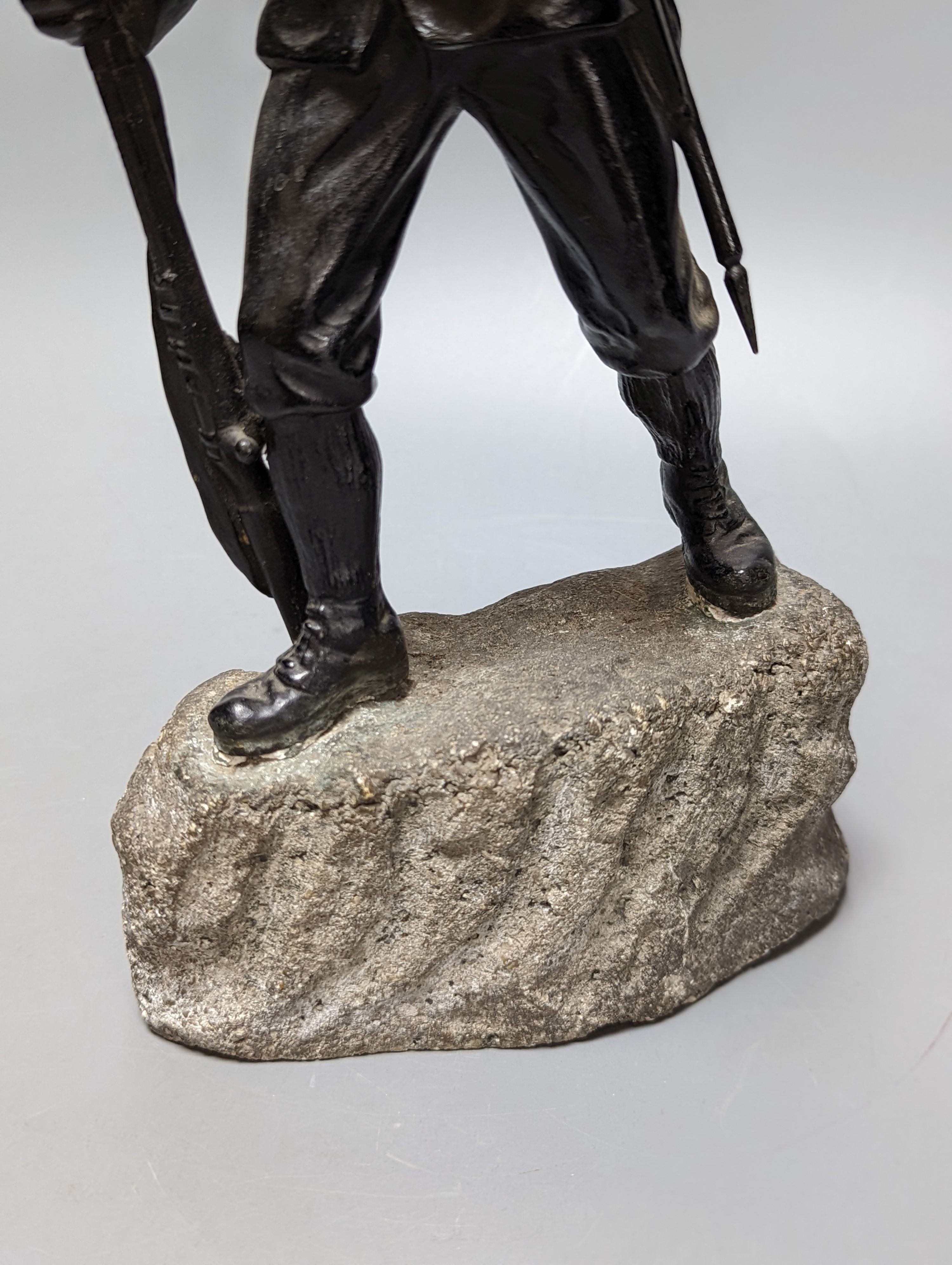 A WW1 period bronze figure of an Austrian soldier, 30 cms high including stone base.
